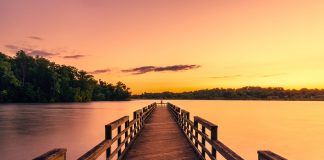 pier overlooking lake at sunset